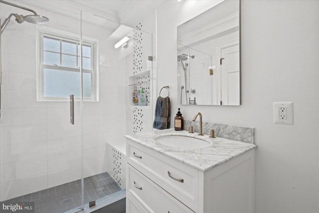 bathroom featuring vanity, crown molding, and a shower with door