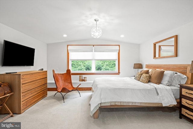 bedroom with carpet floors, a notable chandelier, and vaulted ceiling