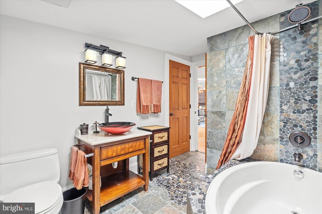 full bathroom featuring vanity, plus walk in shower, and toilet