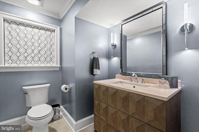 bathroom featuring vanity, crown molding, toilet, and tile patterned floors