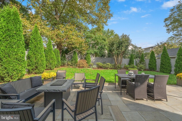 view of patio / terrace featuring an outdoor living space with a fire pit