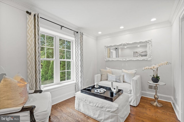 bedroom featuring ornamental molding, multiple windows, and wood-type flooring