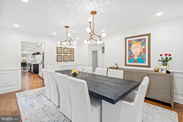 dining area featuring crown molding and hardwood / wood-style floors