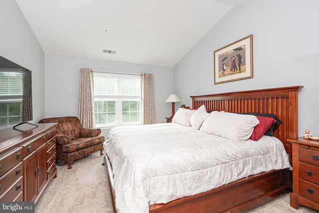 bedroom featuring light carpet and lofted ceiling