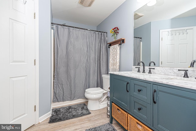 bathroom with a shower with curtain, vanity, hardwood / wood-style floors, and toilet