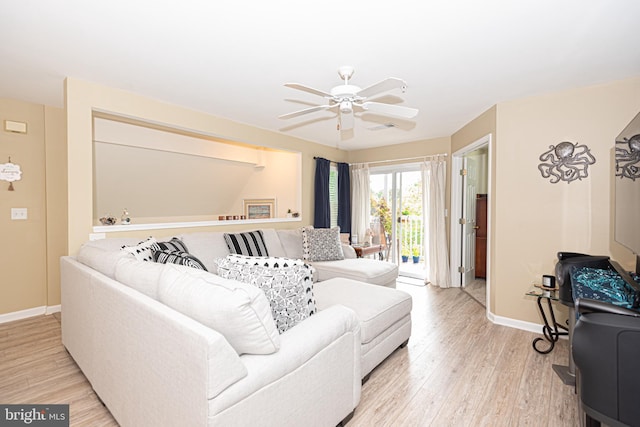 living room with ceiling fan and light hardwood / wood-style flooring