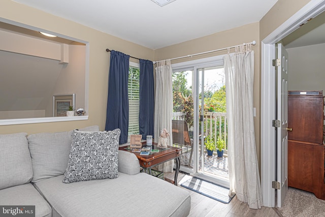 bedroom with hardwood / wood-style floors and access to exterior