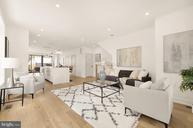 living room with light hardwood / wood-style floors