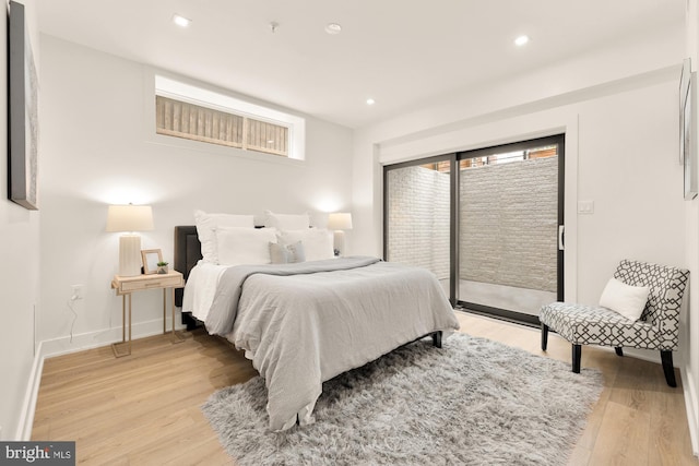 bedroom with access to outside and light hardwood / wood-style flooring