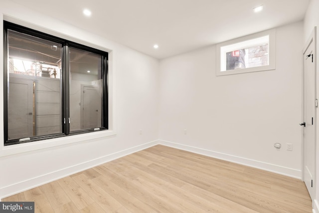 unfurnished room with light hardwood / wood-style floors