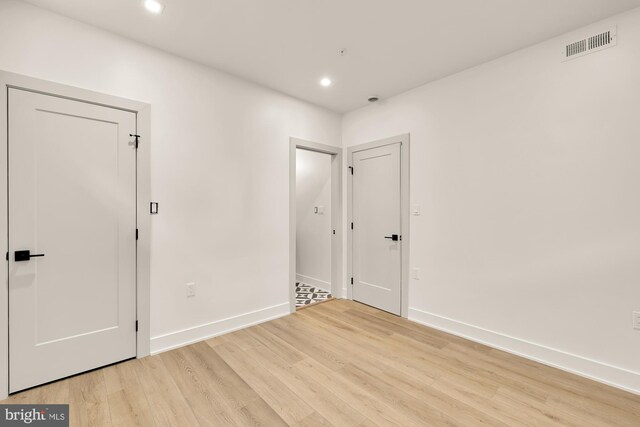 spare room with light hardwood / wood-style floors