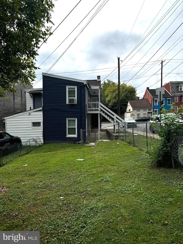 back of house with a lawn