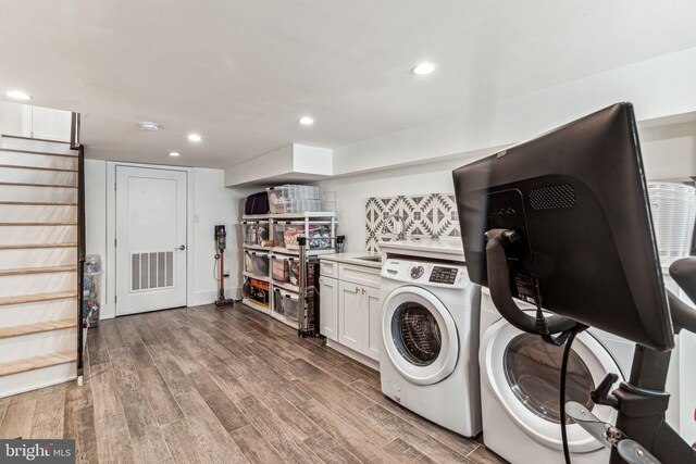 clothes washing area featuring independent washer and dryer and dark hardwood / wood-style flooring