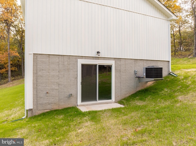 rear view of house featuring a yard and central AC