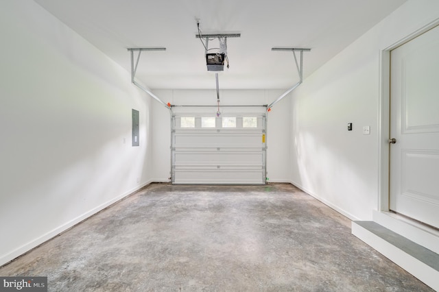 garage with a garage door opener and electric panel