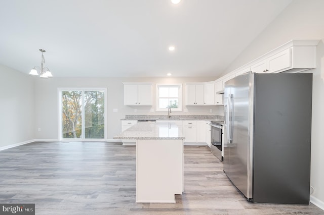 kitchen featuring appliances with stainless steel finishes, a center island, and white cabinetry