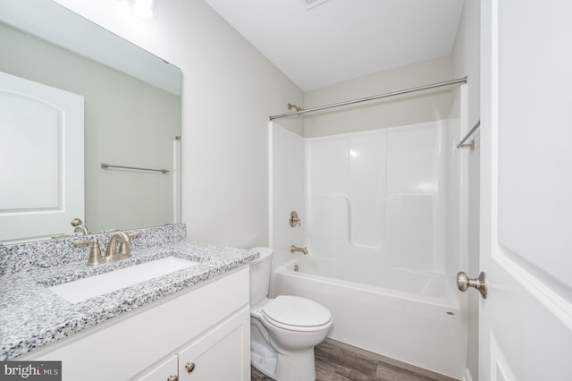 full bathroom with shower / bath combination, hardwood / wood-style flooring, toilet, and vanity