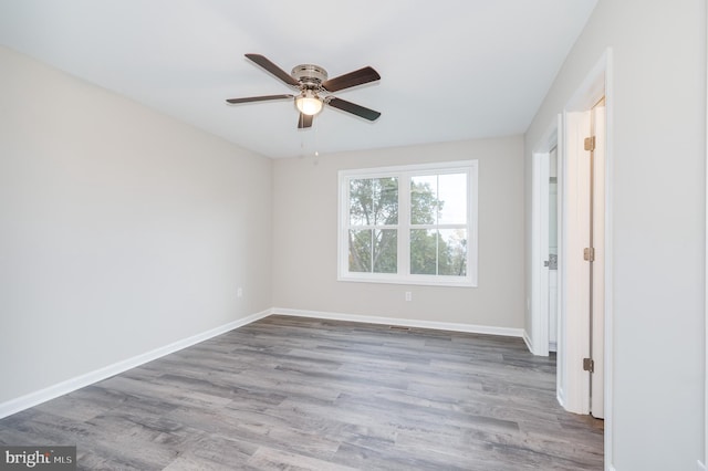 unfurnished room with hardwood / wood-style floors and ceiling fan