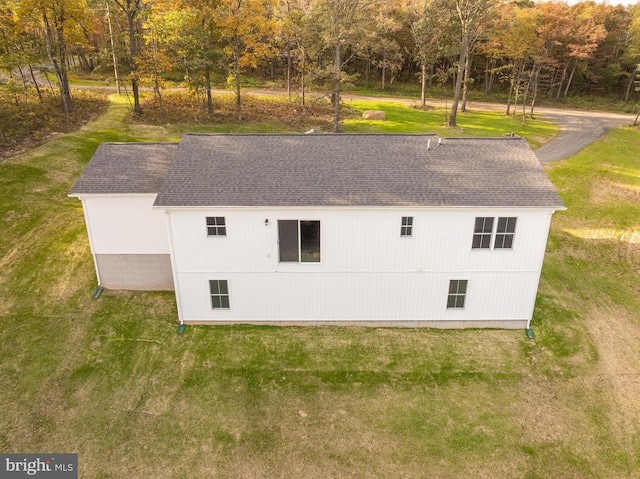 view of property exterior with a yard