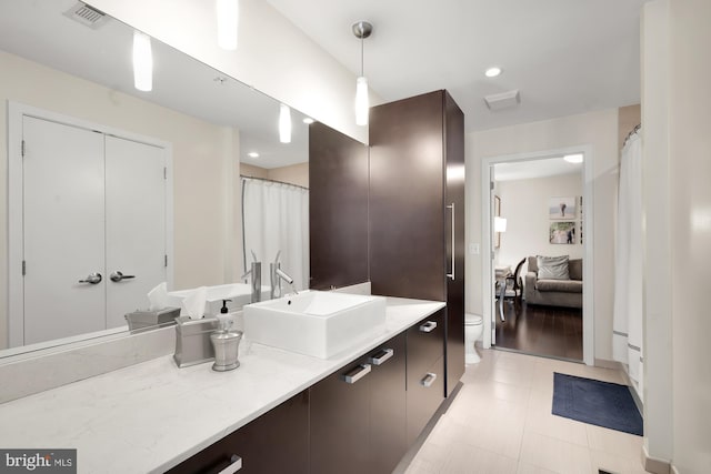 bathroom with hardwood / wood-style floors, vanity, and toilet