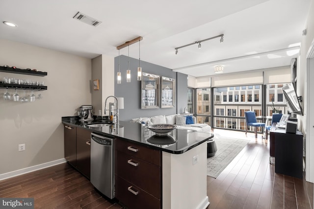 kitchen featuring dark brown cabinetry, sink, dark hardwood / wood-style flooring, kitchen peninsula, and expansive windows