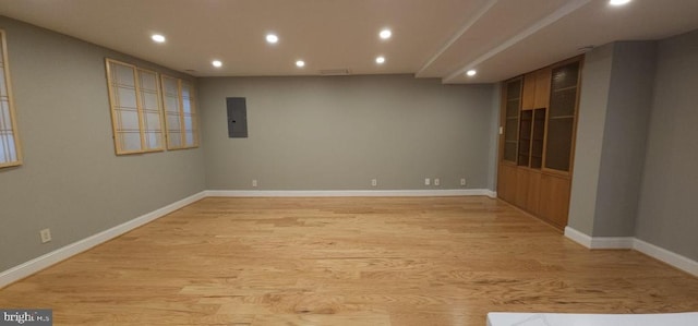 spare room with light hardwood / wood-style flooring and electric panel