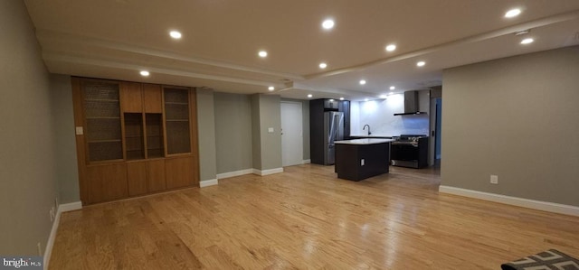 unfurnished living room with light hardwood / wood-style flooring and sink