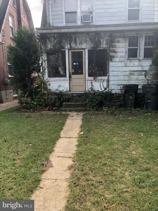 entrance to property with a yard