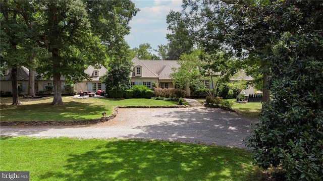 view of home's community featuring a yard and driveway