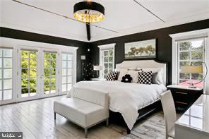 bedroom featuring french doors, access to exterior, and light hardwood / wood-style floors