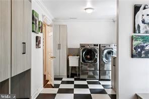 washroom featuring ornamental molding and independent washer and dryer