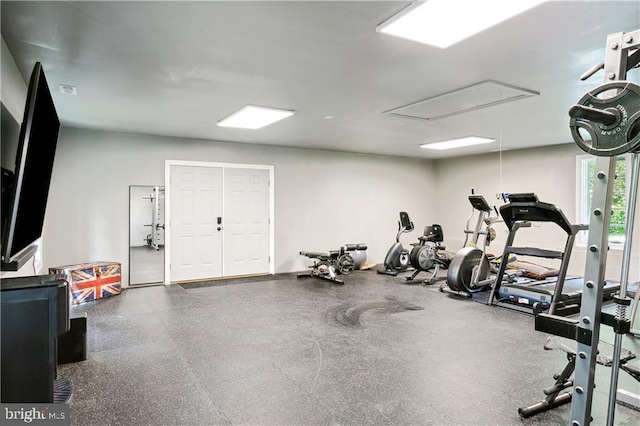 exercise room featuring attic access