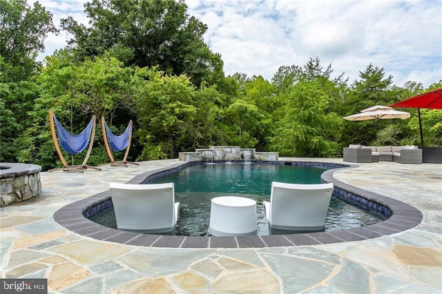 pool featuring a patio area and an outdoor hangout area
