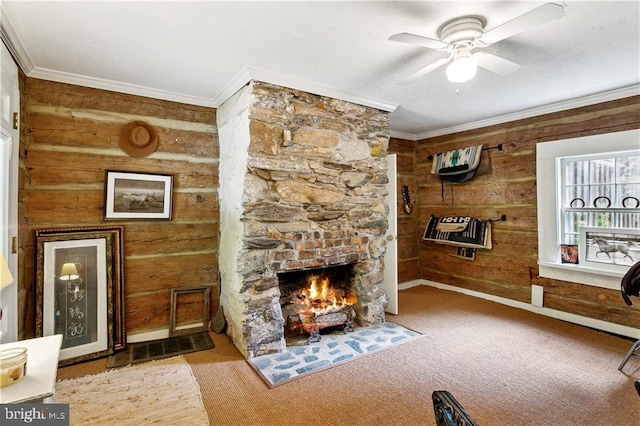 living area featuring crown molding, carpet floors, a ceiling fan, and a fireplace