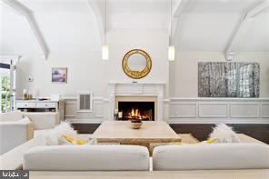 living room featuring vaulted ceiling with beams