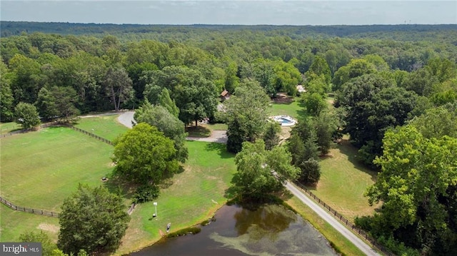 drone / aerial view featuring a rural view and a forest view