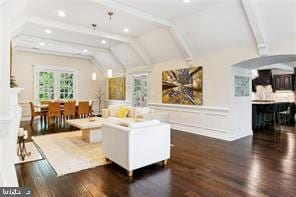 living room featuring vaulted ceiling with beams and dark hardwood / wood-style floors