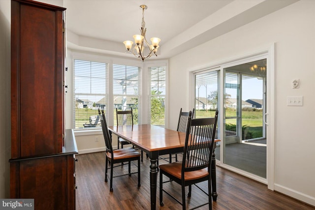 dining area featuring dark hardwood / wood-style flooring and a chandelier