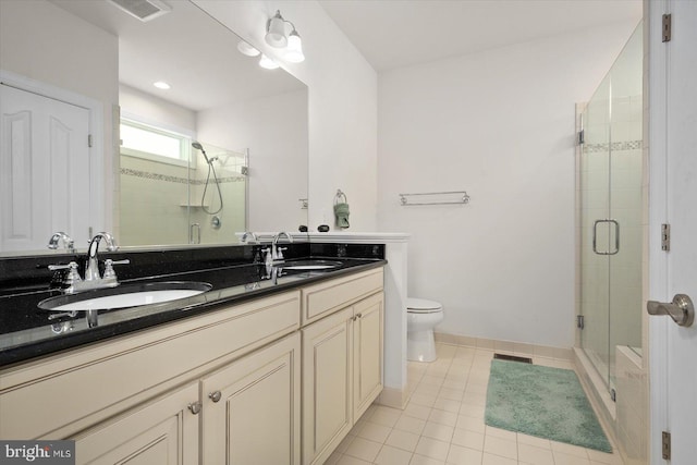 bathroom with toilet, an enclosed shower, vanity, and tile patterned floors