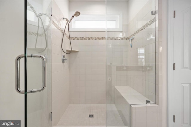 bathroom with a shower with shower door