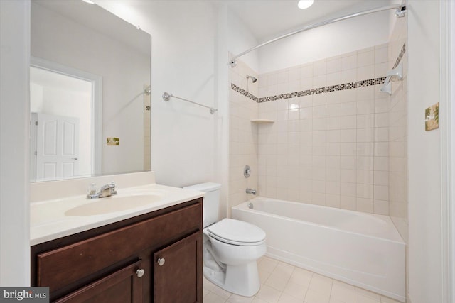 full bathroom with vanity, tile patterned floors, tiled shower / bath, and toilet