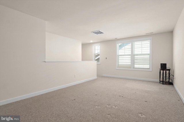 unfurnished room featuring light colored carpet