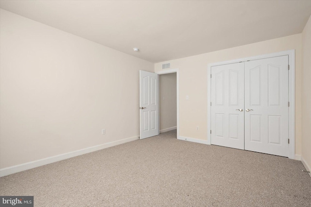 unfurnished bedroom featuring a closet and carpet