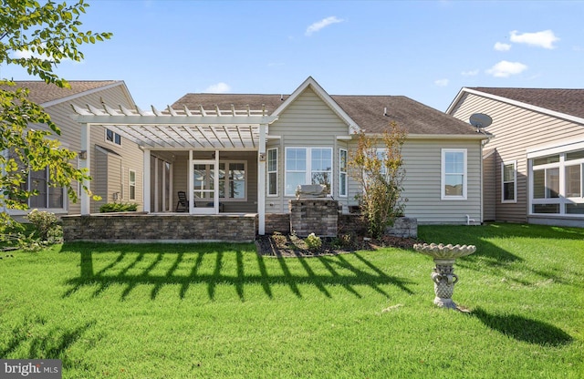 back of house with a pergola and a lawn