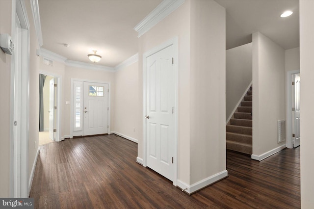 foyer featuring dark wood-type flooring and crown molding