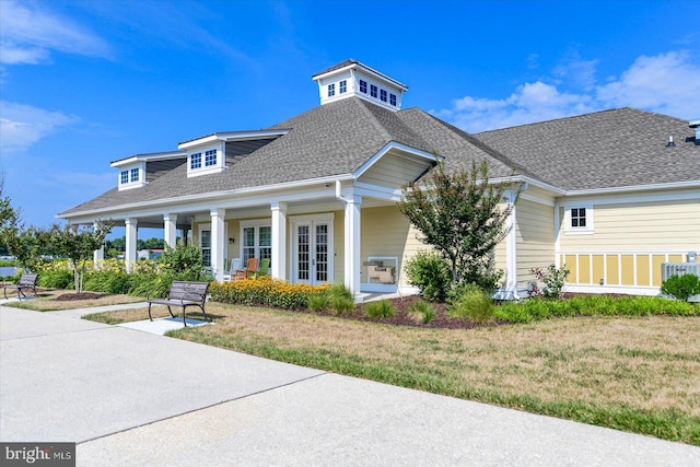 view of front of property featuring central air condition unit and a front yard