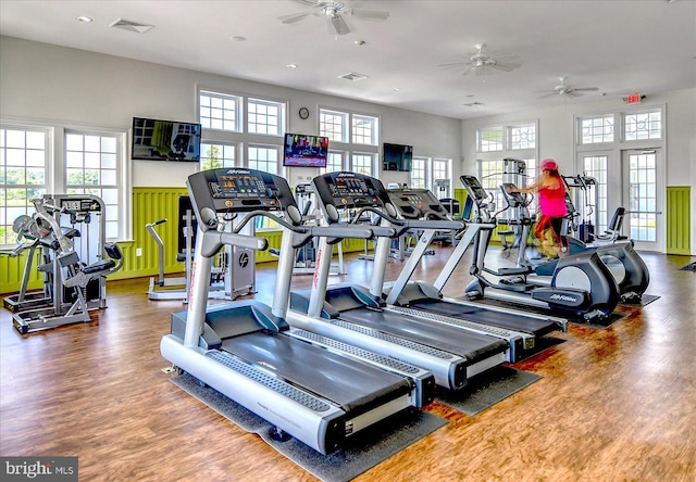 workout area with ceiling fan and wood-type flooring