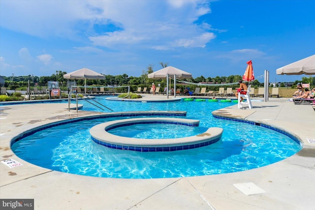 view of pool featuring a patio and a hot tub