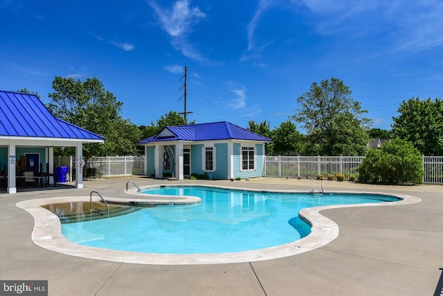 view of pool with a patio and an outdoor structure