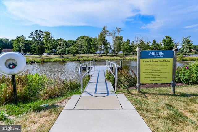 view of property's community with a water view and a boat dock